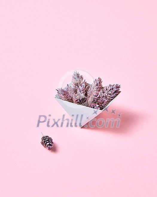 Composition of paper triangular boxes with cones on a pink background with copy space. Layout for postcard Composition of paper triangular boxes with cones on a pink background with copy space. Layout for postcard