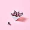 Composition of paper triangular boxes with cones on a pink background with copy space. Layout for postcard