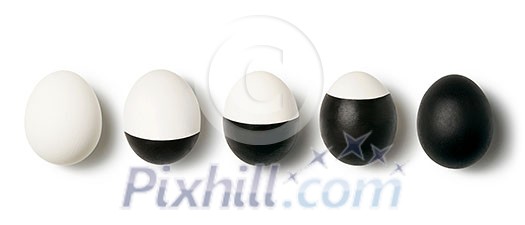 Pattern with row from eggs white and black painted on a white background with place for text. Top view. Concept of dualism yin and yang. Pattern with row from eggs white and black painted on a white background with place for text. Top view. Concept of dualism yin and yang.