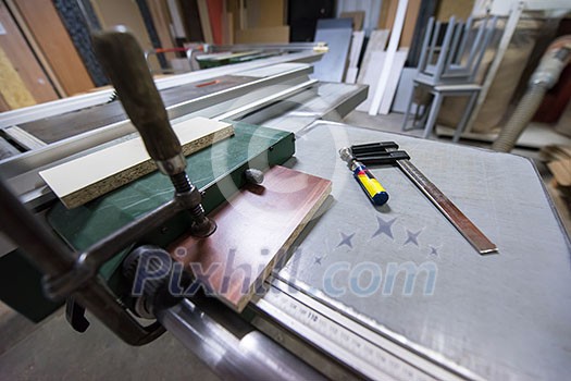 clamp and ruler tools on desk in factory for the production of wooden furniture