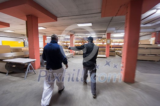 two young carpenters working together in big modern carpentry High quality wood concept two young carpenters working together in big modern carpentry High quality wood concept