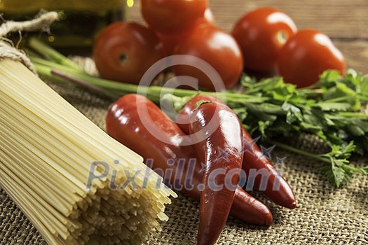 Pasta spaghetti vegetables spices and oil on table Pasta spaghetti vegetables spices and oil on table