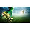 Foot of soccer player kicking ball. Mixed media