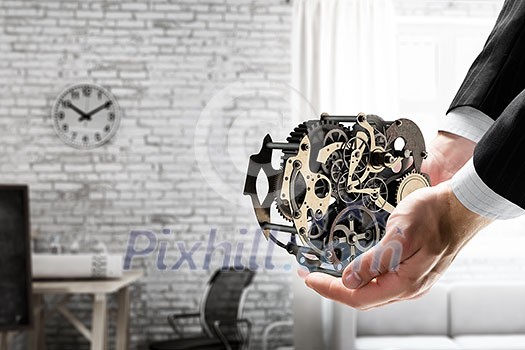 Metal gear mechanism in palm. Mixed media Metal gear mechanism in palm. Mixed media