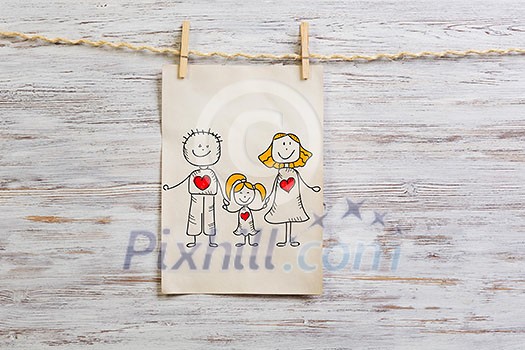 Paper sheet hanging on rope against wooden surface. Mixed media Paper sheet hanging on rope against wooden surface. Mixed media