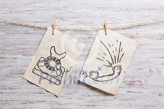 Paper sheet hanging on rope against wooden surface. Mixed media Paper sheet hanging on rope against wooden surface. Mixed media