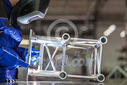 Industrial workers welding metal with many sharp sparks, Welder working a welding metal with protective mask and sparks Industrial workers welding metal with many sharp sparks, Welder working a welding metal with protective mask and sparks