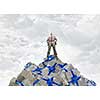 Young businessman among pile of gift boxes. Mixed media