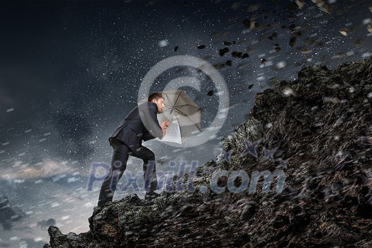 Businessman protects himself from the crisis. Mixed media Businessman protects himself from the crisis. Mixed media
