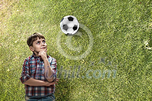 Cute boy of school age with hand on chin looking up. Mixed media Cute boy of school age with hand on chin looking up. Mixed media