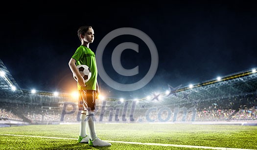 Kid boy in uniform on soccer field looking away. Mixed media Kid boy in uniform on soccer field looking away. Mixed media