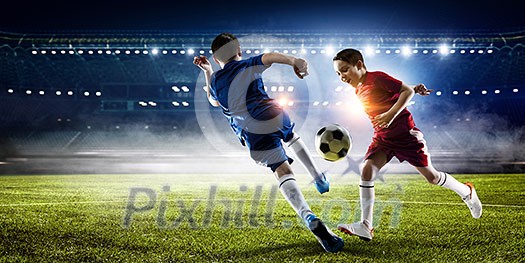 Kid boys in uniform on soccer field fighting for ball. Mixed media Kid boys in uniform on soccer field fighting for ball. Mixed media