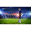 Kid boy in uniform on soccer field looking away. Mixed media