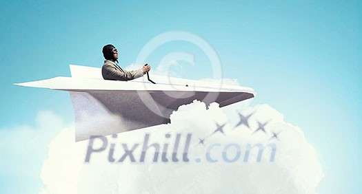 Funny pilot sitting in paper plane. Mixed media Funny pilot sitting in paper plane. Mixed media