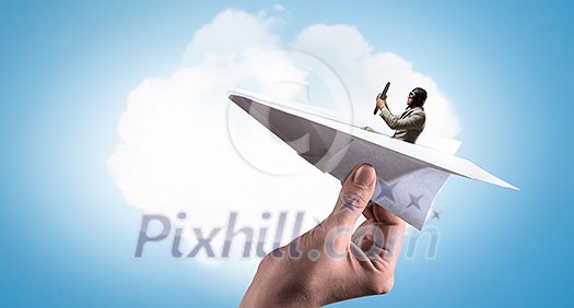 Funny pilot sitting in paper plane. Mixed media Funny pilot sitting in paper plane. Mixed media