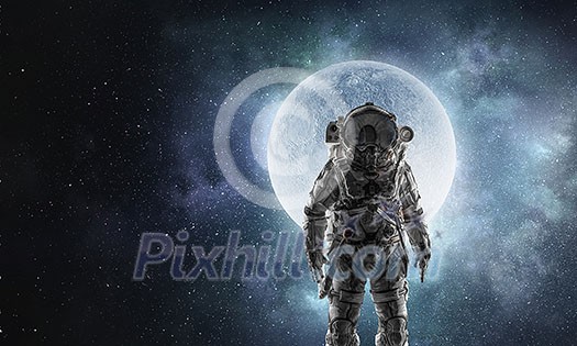 Spaceman wearing astronaut suit outdoor. Mixed media Spaceman wearing astronaut suit outdoor. Mixed media