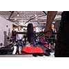 group of young healthy sporty women working out with instructor using barbells while exercises in a fitness studio  fitness, sport, training, gym and lifestyle concept