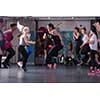 group of young healthy sporty women working out with instructor doing aerobics exercises in a fitness studio fitness, sport, training, gym and lifestyle concept