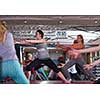 group of young healthy sporty women working out with instructor doing aerobics exercises in a fitness studio fitness, sport, training, gym and lifestyle concept