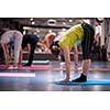group of young healthy sporty women working out with instructor doing aerobics exercises in a fitness studio fitness, sport, training, gym and lifestyle concept