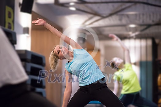 group of young healthy sporty women working out with instructor doing aerobics exercises in a fitness studio fitness, sport, training, gym and lifestyle concept group of young healthy sporty women working out with instructor doing aerobics exercises in a fitness studio fitness, sport, training, gym and lifestyle concept
