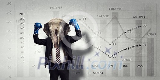 Businessman with elephant head wearingn boxing gloves. Mixed media Businessman with elephant head wearingn boxing gloves. Mixed media