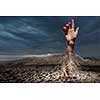 Hand coming out of ground as concept for never give up