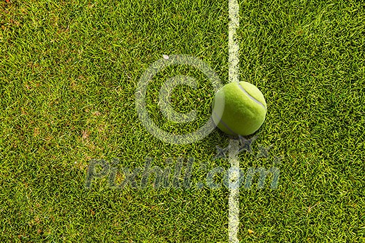 Big tennis ball on line of field Big tennis ball on line of field