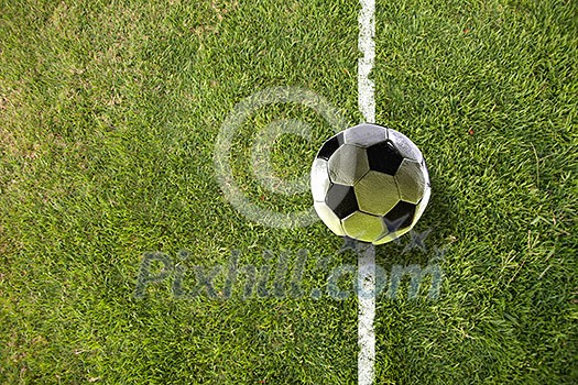 Traditional soccer ball on soccer green field Traditional soccer ball on soccer green field