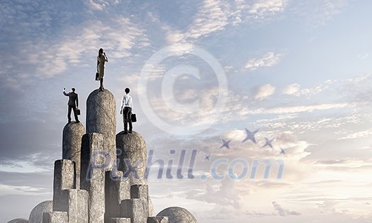Tean of businesspeople on top of stone column. Mixed media Tean of businesspeople on top of stone column. Mixed media