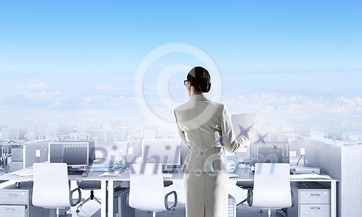 Business lady in suit and open-plan office with many tables. Mixed media Business lady in suit and open-plan office with many tables. Mixed media