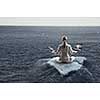 Businesswoman in lotus pose floating on ice block. Mixed media