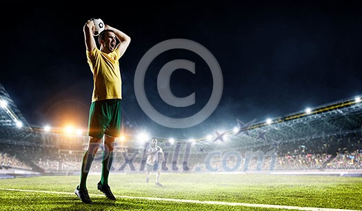 Soccer player ready to throw ball in the stadium. Mixed media Soccer player ready to throw ball in the stadium. Mixed media