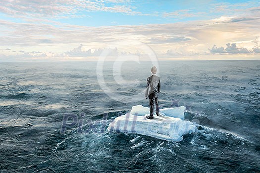 Businessman on ice block floating in sea . Mixed media Businessman on ice block floating in sea . Mixed media