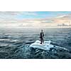 Businessman on ice block floating in sea . Mixed media