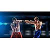 Two boxers fighting in lights of arena. Mixed media