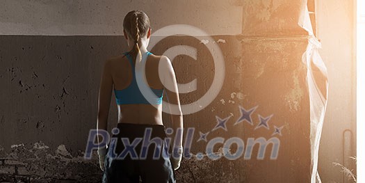 Young attractive girl boxer with bandages on hands. Mixed media Young attractive girl boxer with bandages on hands. Mixed media