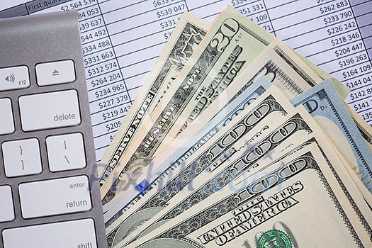 Money cash banknotes calculations and computer keyboard on table Money cash banknotes calculations and computer keyboard on table