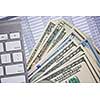 Money cash banknotes calculations and computer keyboard on table