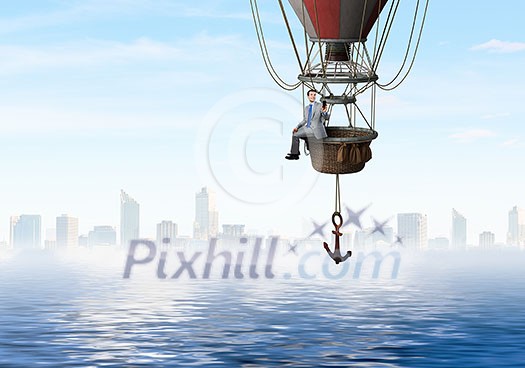 Color aerostat flying above sea and businessman with mobile phone Color aerostat flying above sea and businessman with mobile phone