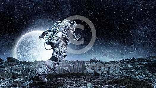 Astronaut in space suit running on planet surface. Mixed media Astronaut in space suit running on planet surface. Mixed media