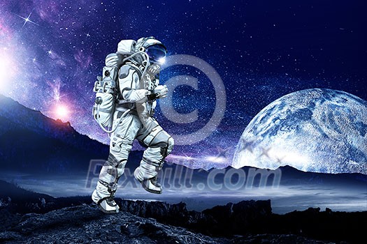Astronaut in space suit running on planet surface. Mixed media Astronaut in space suit running on planet surface. Mixed media