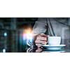 Double exposure of businesswoman hand with coffee cup and media technologies