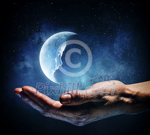 Moon planet lying on palm. Mixed media Moon planet lying on palm. Mixed media