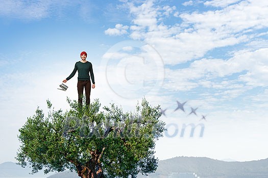 Hipster guy water green tree with metal can. Mixed media Hipster guy water green tree with metal can. Mixed media