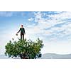 Hipster guy water green tree with metal can. Mixed media