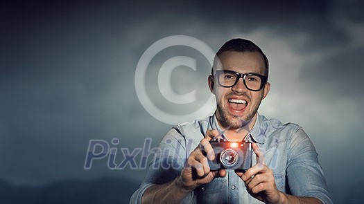 Hipster man in glasses with old photo camera Hipster man in glasses with old photo camera