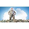 Rich businessman in pile of money banknotes