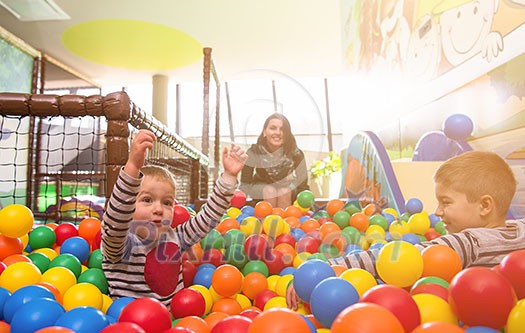 happy family enjoying free time young mom playing with kids in pool with colorful balls at childrens playroom happy family enjoying free time young mom playing with kids in pool with colorful balls at childrens playroom