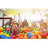 happy family enjoying free time young mom playing with kids in pool with colorful balls at childrens playroom
